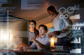 Cracking codes no matter the time. Shot of computer programmers looking through data in the office.