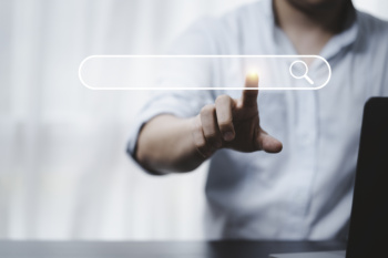 Hand touching with search icon for Search Engine Optimisation or