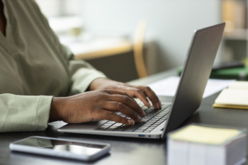 side-view-worker-typing-laptop