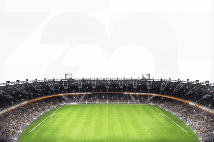 Estádio de futebol iluminado representando a Copa do Mundo 2026, com o número 26 ao fundo em composição minimalista.